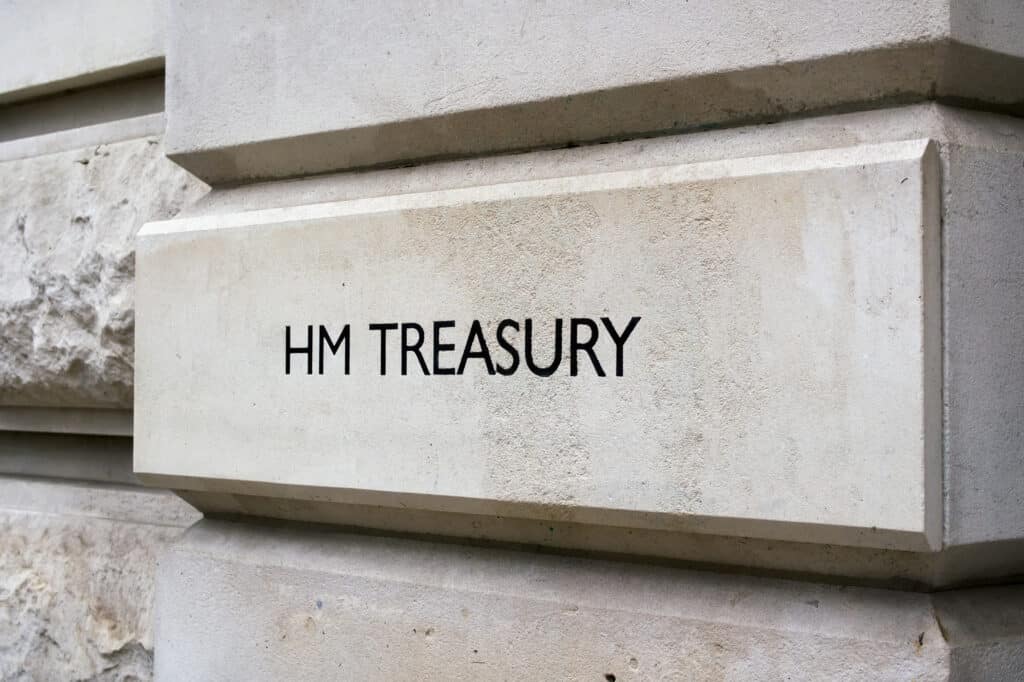 A stone wall with the words "HM TREASURY" engraved on it, indicating the location of the UK's government department responsible for economic and financial matters. The surface is smooth with some rougher stone texture visible on the left. ©Mobysoft