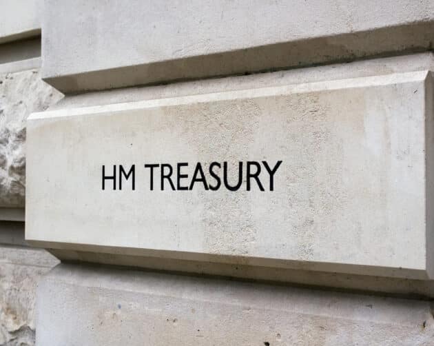 A stone wall with the words "HM TREASURY" engraved on it, indicating the location of the UK's government department responsible for economic and financial matters. The surface is smooth with some rougher stone texture visible on the left. ©Mobysoft